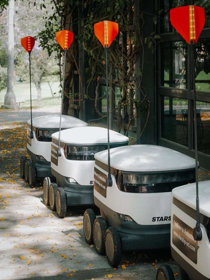 Delivery Robots Parked Beside Glass Wall